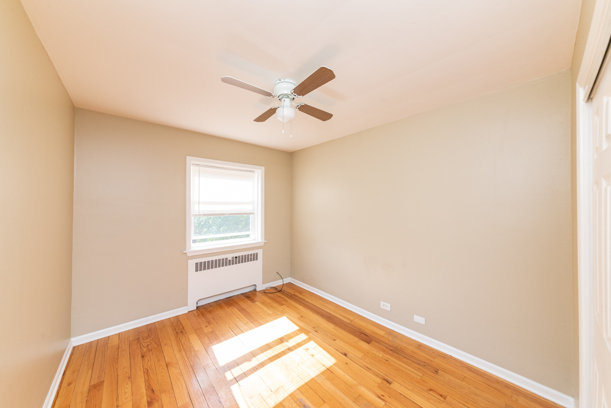 233 Custer Avenue, Unit 3 Evanston, IL 60202 - Photo 13 of 13 a view of a room with wooden floor and fan