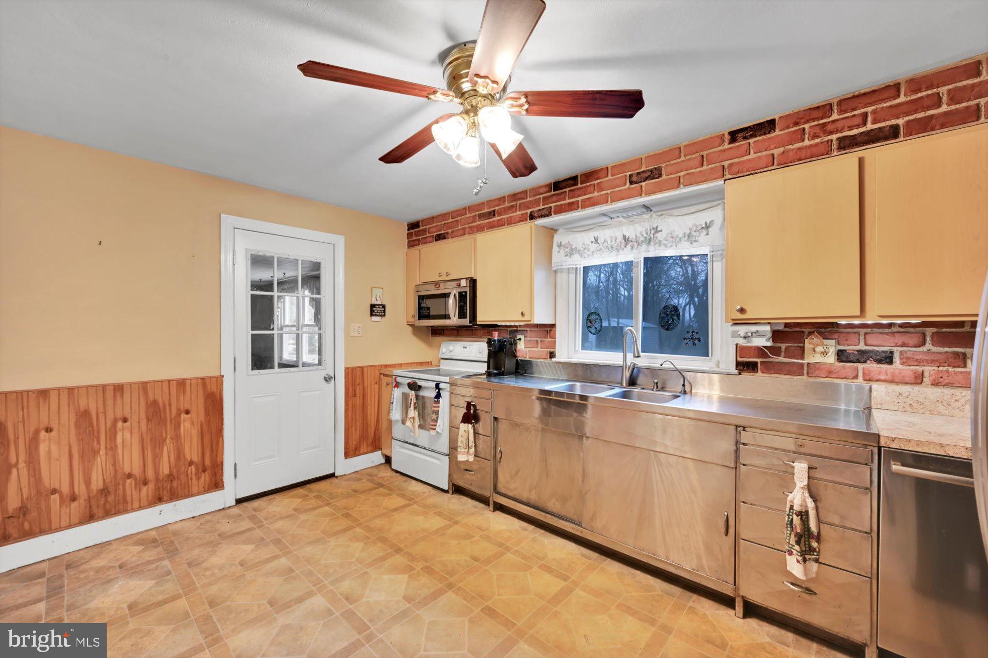 1130 Van Reed Road Reading, PA 19605 - Photo 11 of 39 a large kitchen with a large window appliances and cabinets