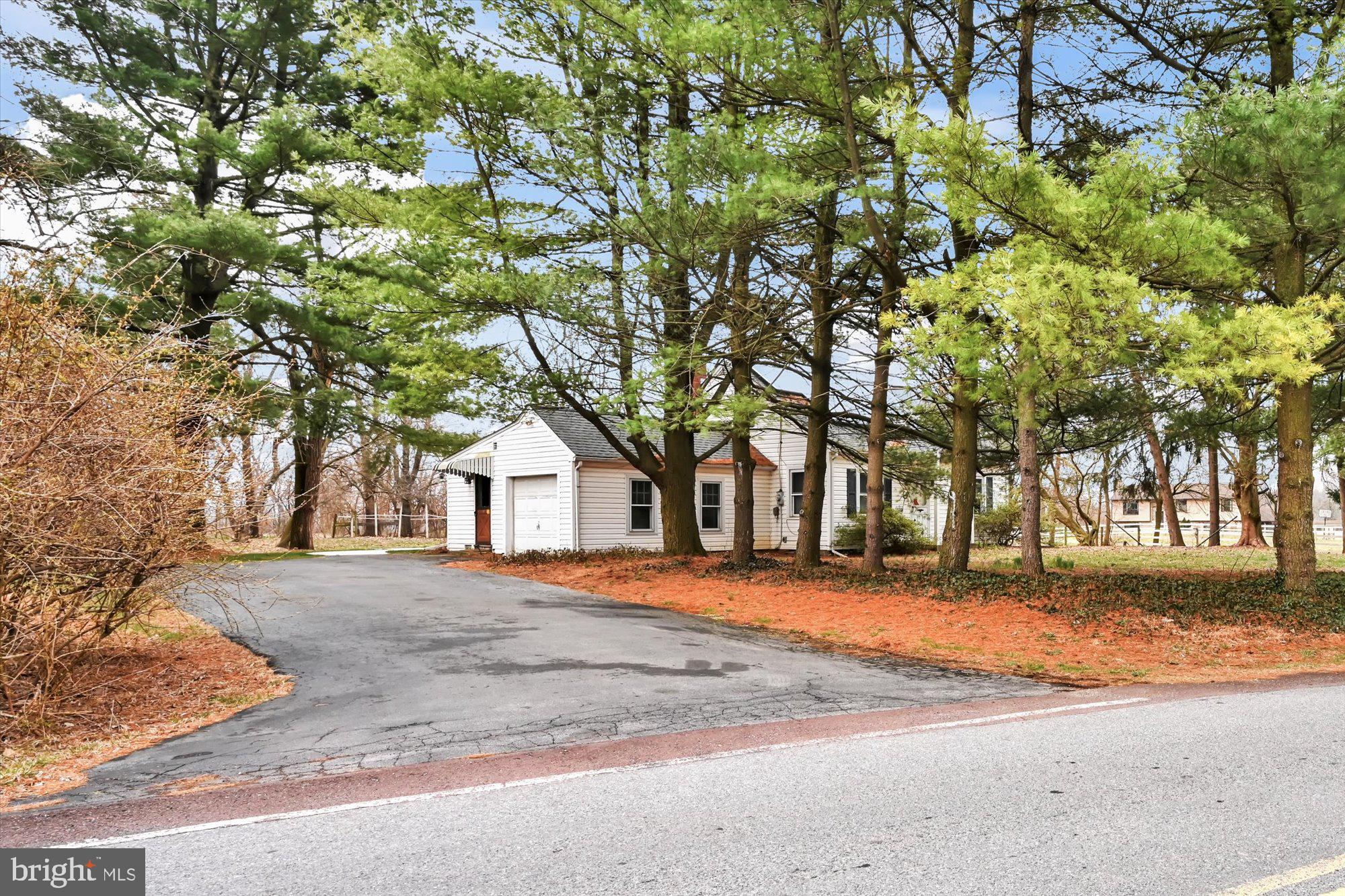 1130 Van Reed Road Reading, PA 19605 - Photo 3 of 39 a front view of a house with a yard and garage