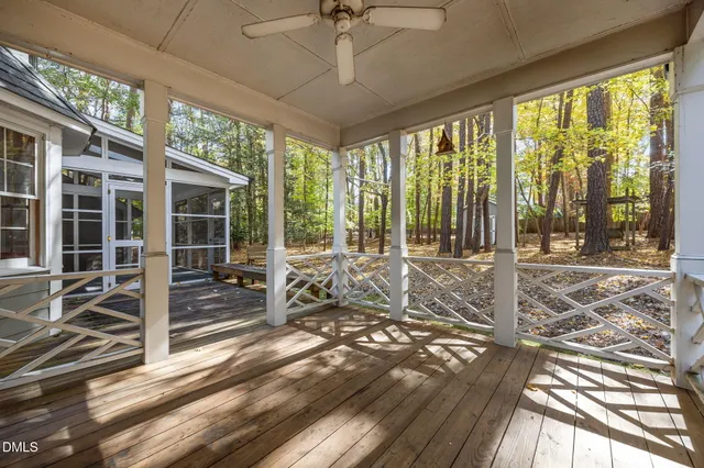 a living room with hardwood floor and large windows