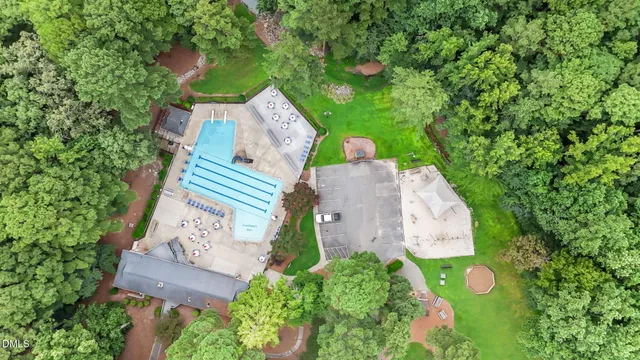 an aerial view of a house with garden space and street view