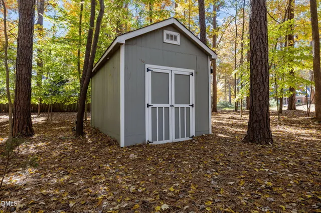 a view of a backyard with a large tree