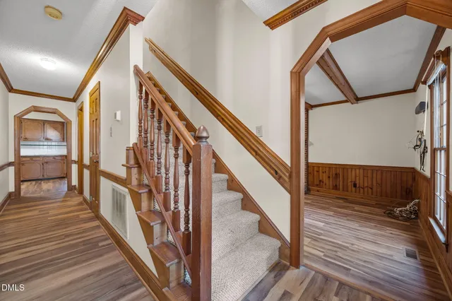 a view of staircase with wooden floor and metal railing