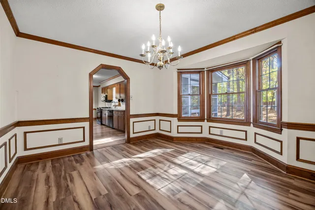 a bedroom with furniture and a large window