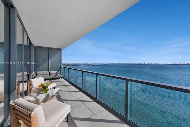 a view of balcony with couches and wooden floor