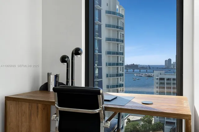 a view of a room with a desk and chair