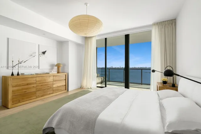 a bedroom with a large bed and a large window