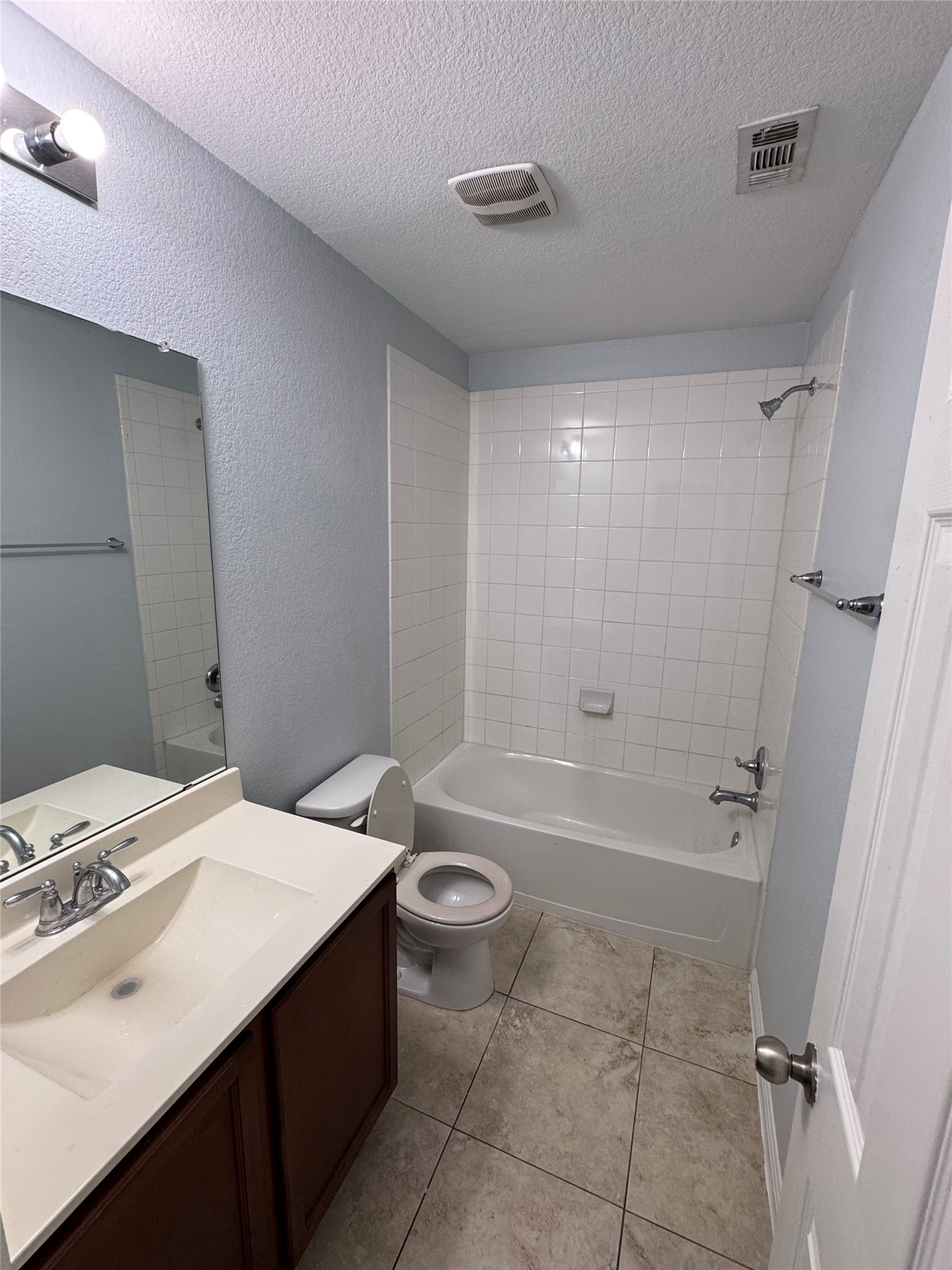1520 Portchester Castle Path Pflugerville, TX 78660 - Photo 19 of 26 A full bathroom features a vanity, tiled flooring, and a shower-tub combination.