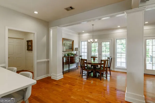 a kitchen with a sink and chairs