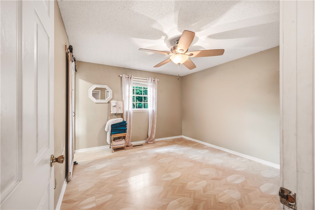 2001 Ridgeview Lane Seneca, SC 29678 - Photo 16 of 27 A well-lit bedroom featuring a distinctive geometric-patterned wood floor.