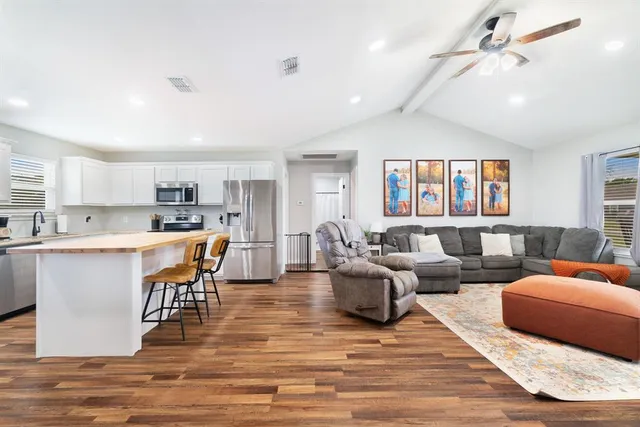 a living room with furniture and kitchen view