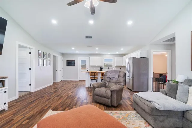 a living room with furniture and a chandelier