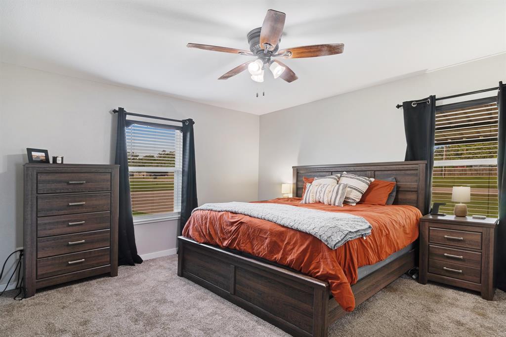 21 Private Road Paris, TX 75462 - Photo 8 of 15 Bedroom with light colored carpet and ceiling fan
