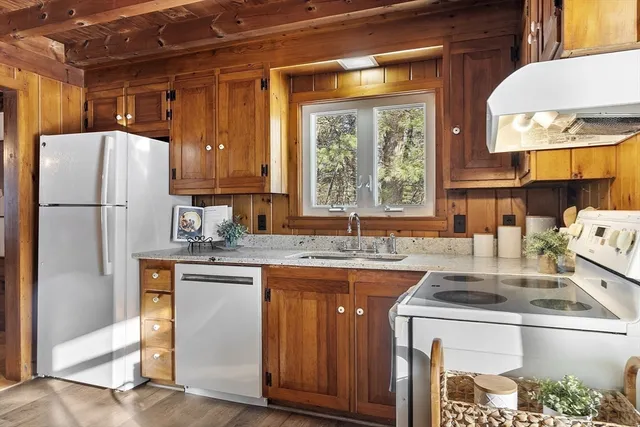 a kitchen with a sink a refrigerator and a stove
