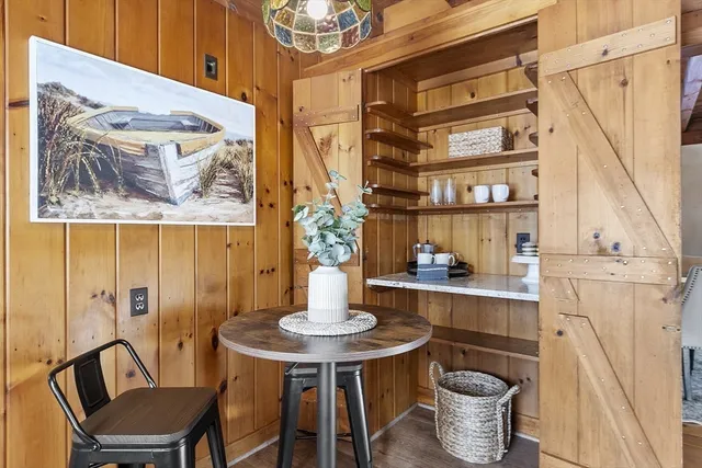 a dining room with furniture and wooden floor
