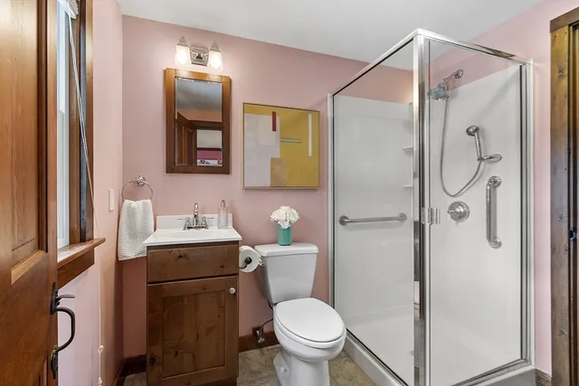 a bathroom with a granite countertop toilet sink and shower