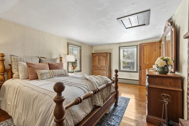 a bedroom with bed and wooden floor