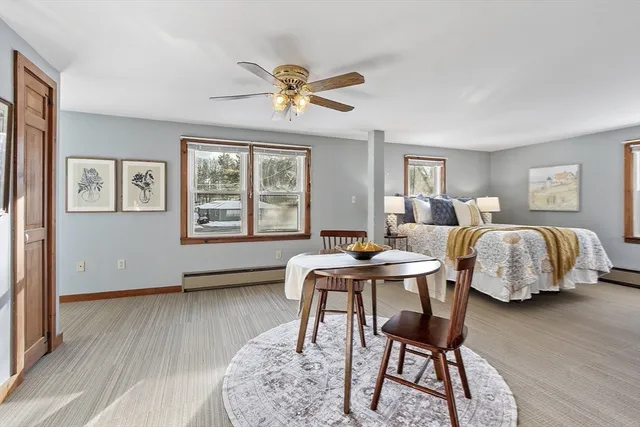a living room with a bed furniture and a window
