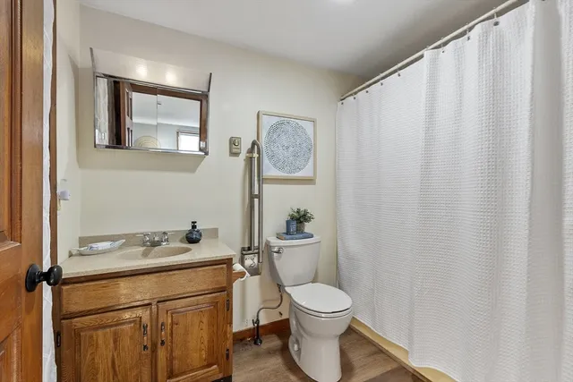 a bathroom with a toilet a sink and a window