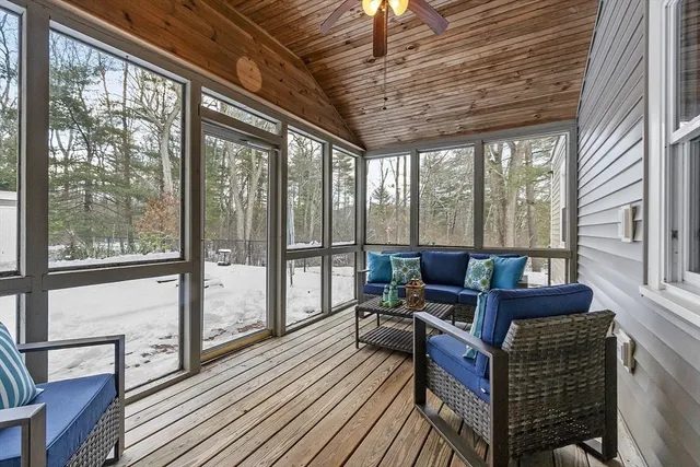 a living room with furniture a wooden floor and next to a ceiling window