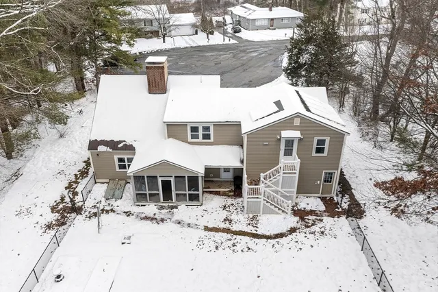a front view of a house with snow on side