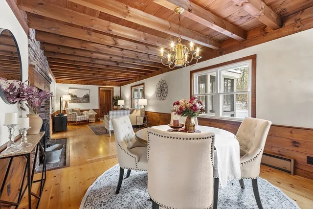 a dining room with furniture wooden floor and a potted plant