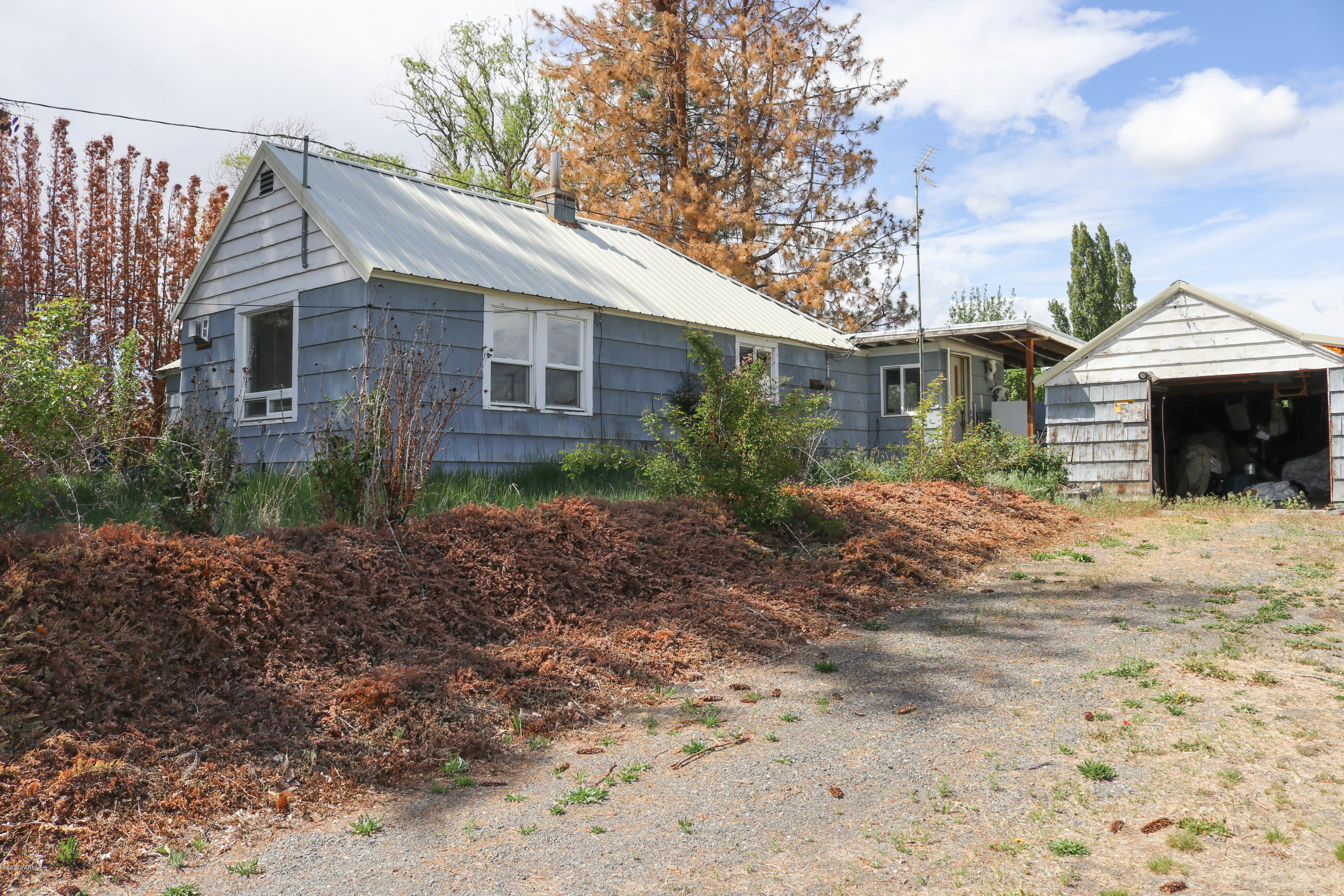 2412 Carlson Road Yakima, WA 98903 - Photo 1 of 24 a front view of a house with garden