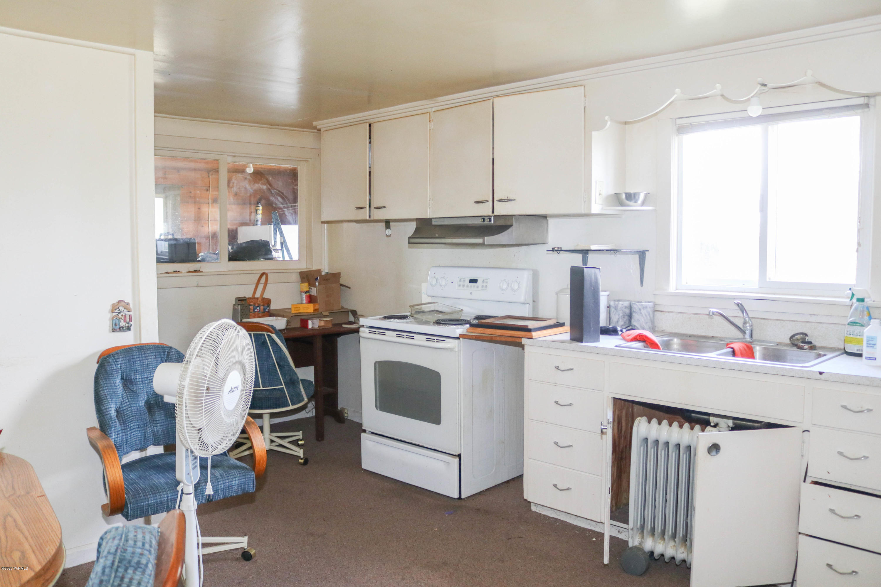 2412 Carlson Road Yakima, WA 98903 - Photo 6 of 24 a room with a white cabinets washer and dryer