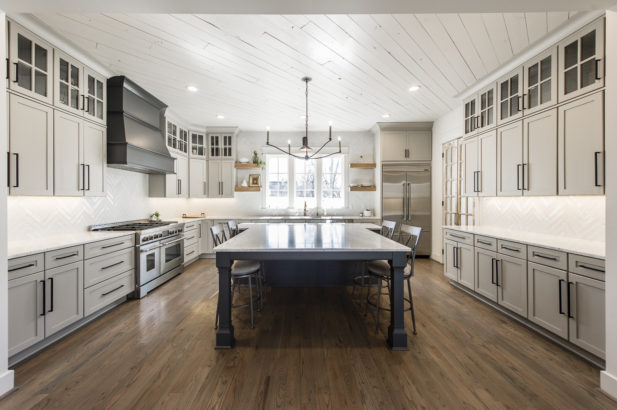1132 Glenwood Avenue Nashville, TN 37204 - Photo 16 of 61 a kitchen with stainless steel appliances granite countertop a kitchen island hardwood floor sink stove dining table and chairs