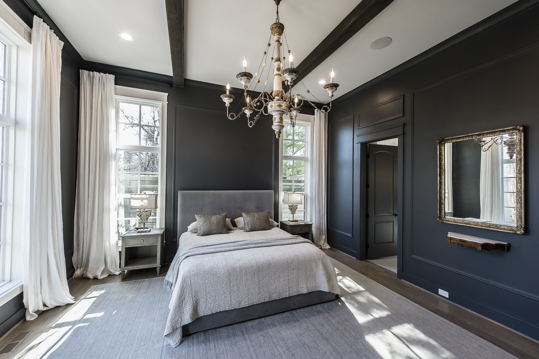 1132 Glenwood Avenue Nashville, TN 37204 - Photo 29 of 61 a bedroom with a large bed and a chandelier