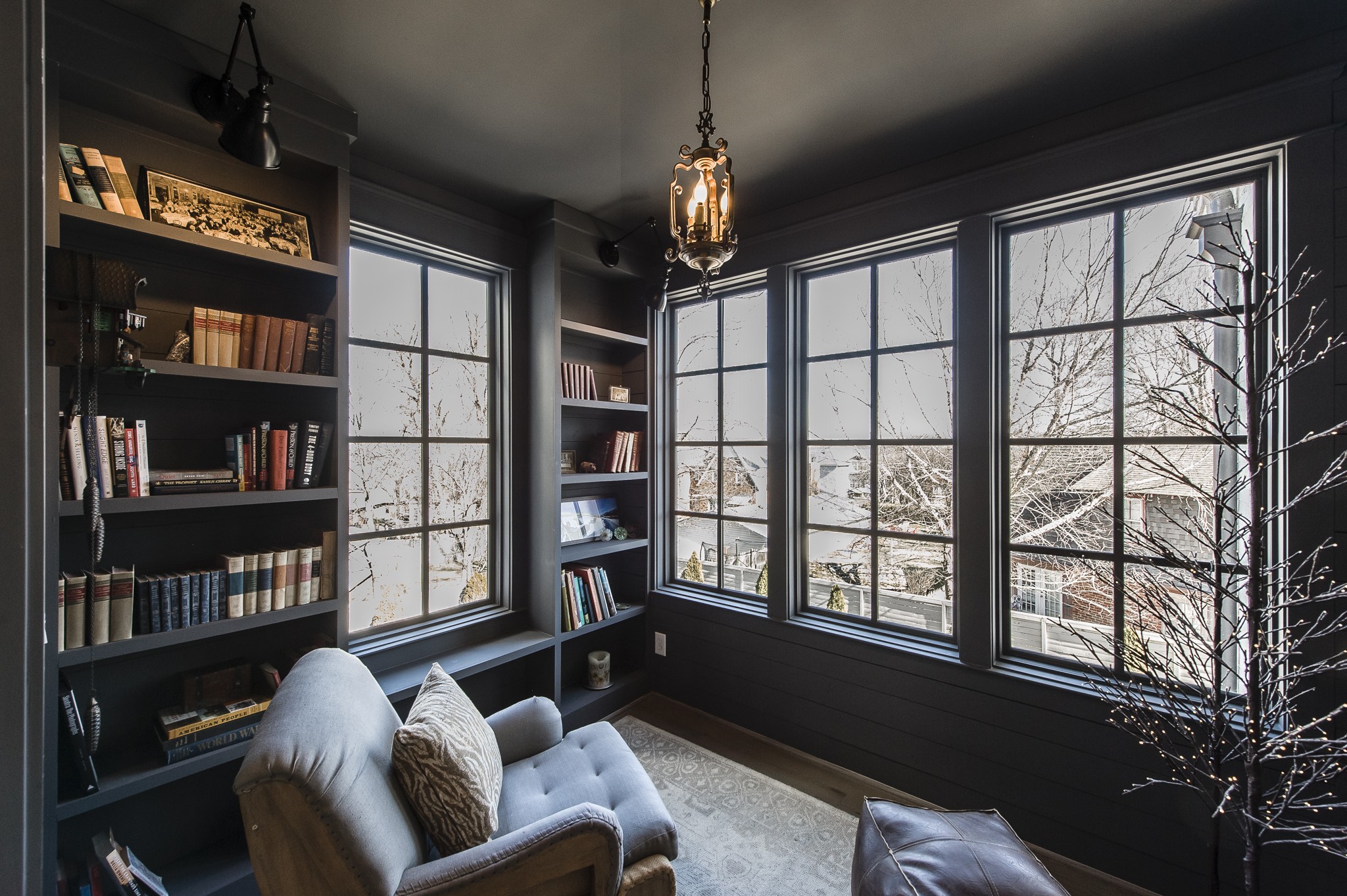 1132 Glenwood Avenue Nashville, TN 37204 - Photo 38 of 61 a living room with furniture a bookshelf window and a flat screen tv