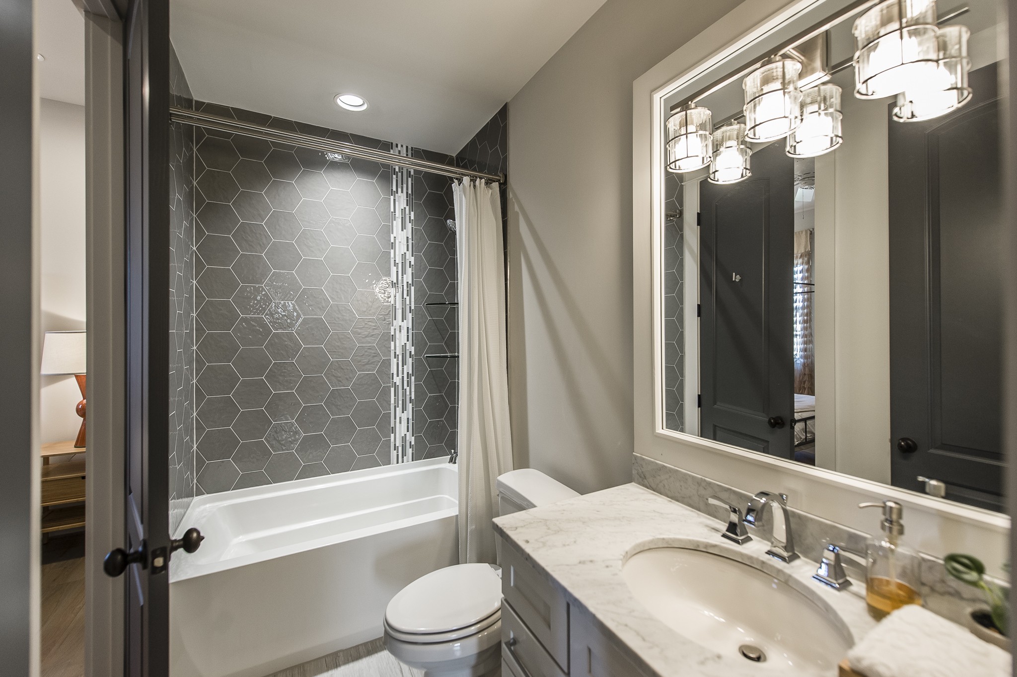 1132 Glenwood Avenue Nashville, TN 37204 - Photo 41 of 61 a bathroom with a sink a toilet and a large mirror