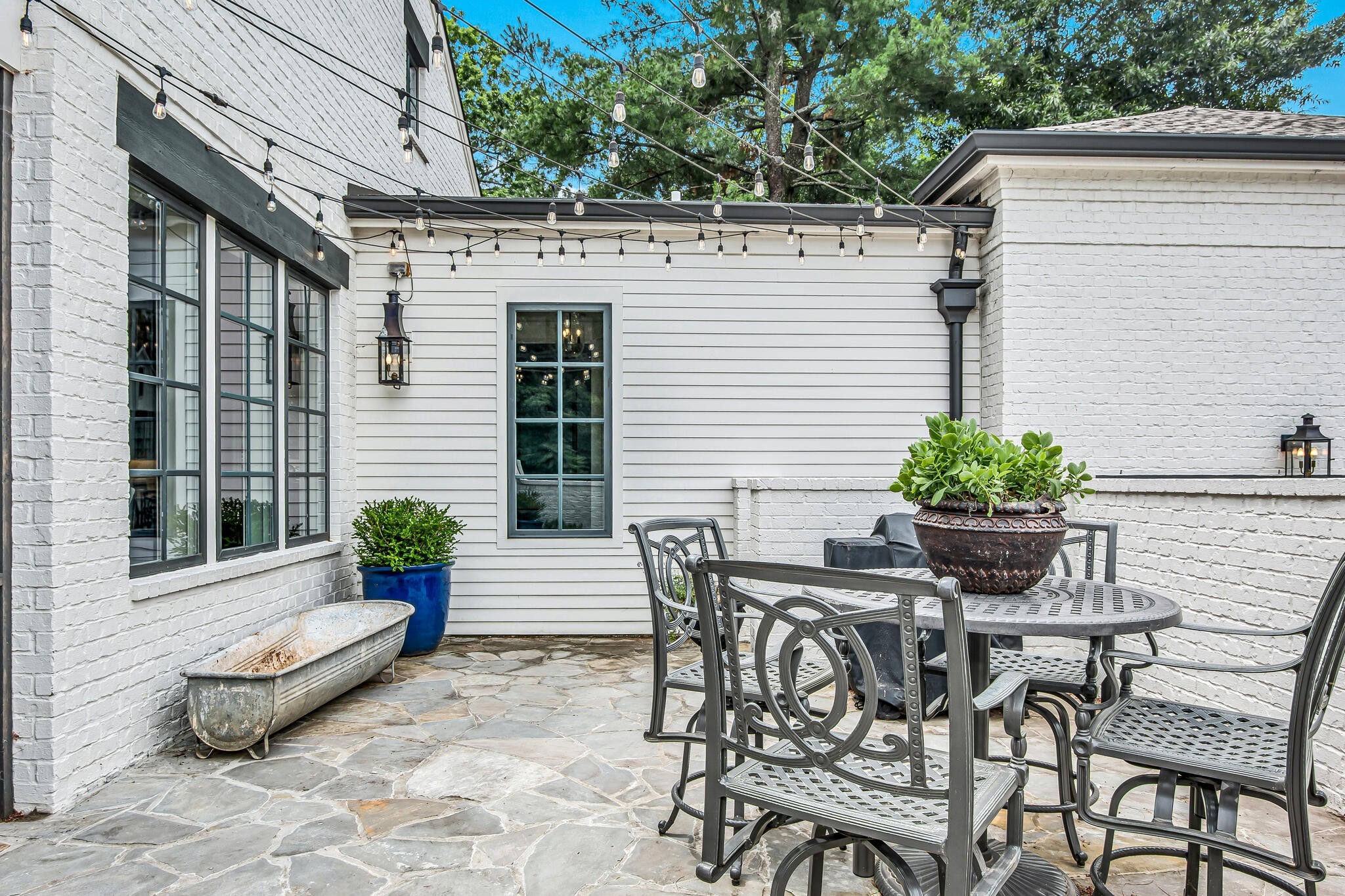 1132 Glenwood Avenue Nashville, TN 37204 - Photo 60 of 61 a view of a patio with table and chairs and potted plants
