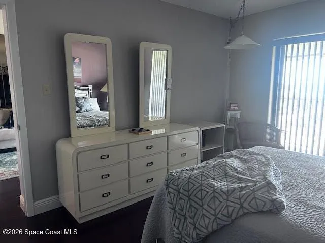 a bedroom with a bed and a dresser in it