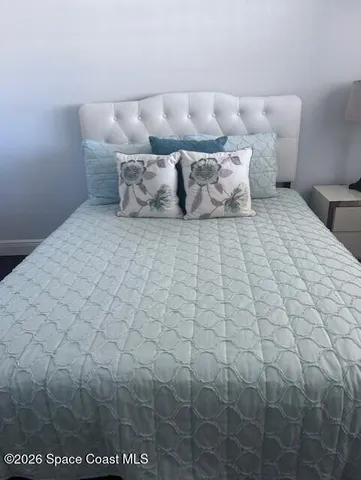 a bedroom with a bed and a night stand