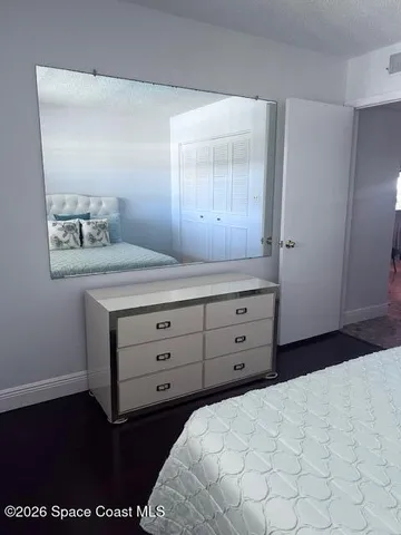 a bedroom with a bed and a night stand