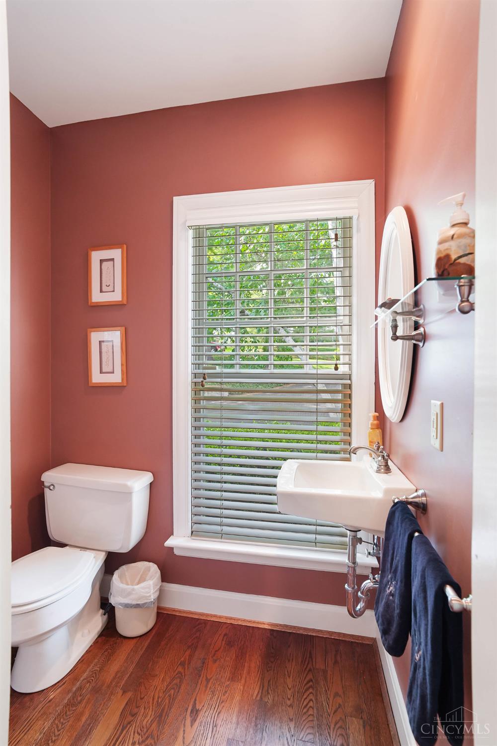 2780 Walsh Road Cincinnati, OH 45208 - Photo 16 of 68 This convenient first-floor powder room (one of two on the first floor) is thoughtfully positioned off the main living areas. Featuring a pedestal sink, warm tones and a window that fills the space with natural light, this secondary powder room offers a comfortable and convenient option for everyday use.