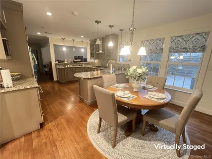 a dining room with furniture a kitchen view and a chandelier