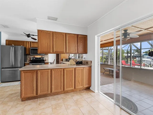a kitchen with a refrigerator a microwave a sink and a stove