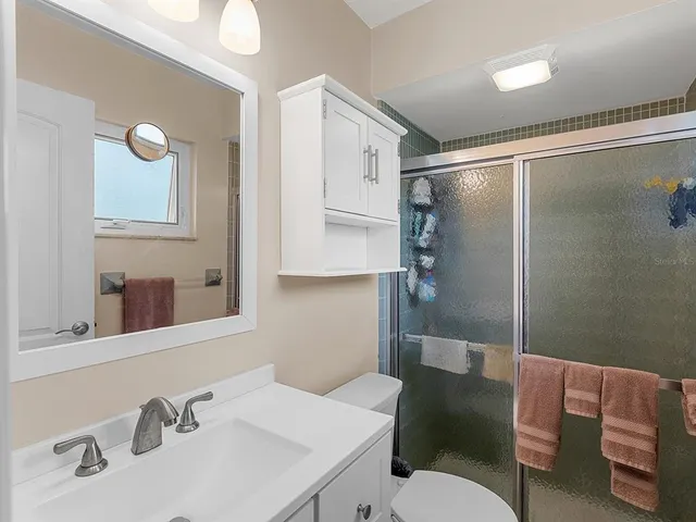 a bathroom with a sink toilet and shower