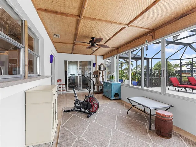 a view of a patio with table and chairs and potted plants