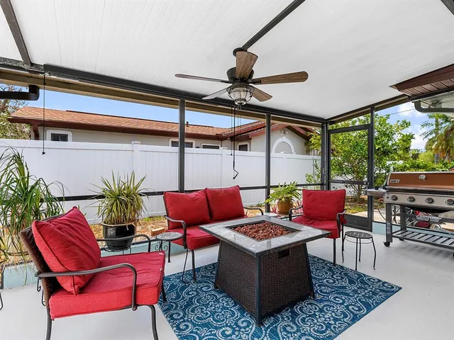 a living room with furniture a rug and a table