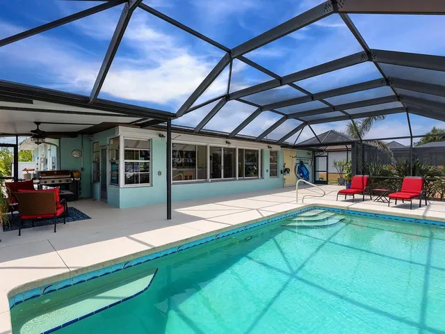 a view of a backyard with table and chairs with wooden floor