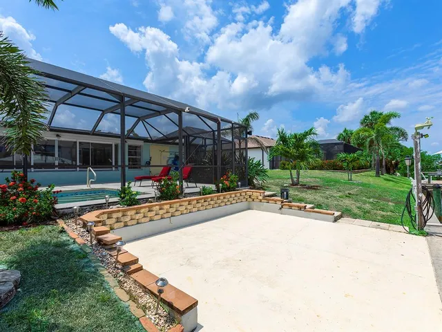 a view of a patio with a table and chairs under an umbrella