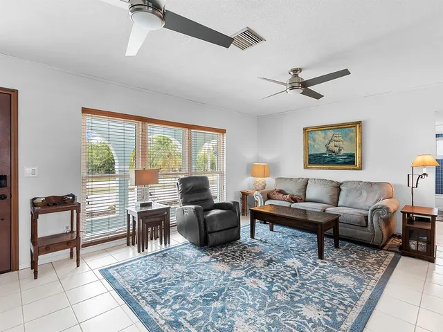 a living room with furniture rug and a window
