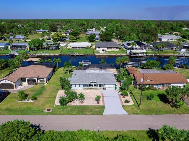 an aerial view of multiple houses with yard