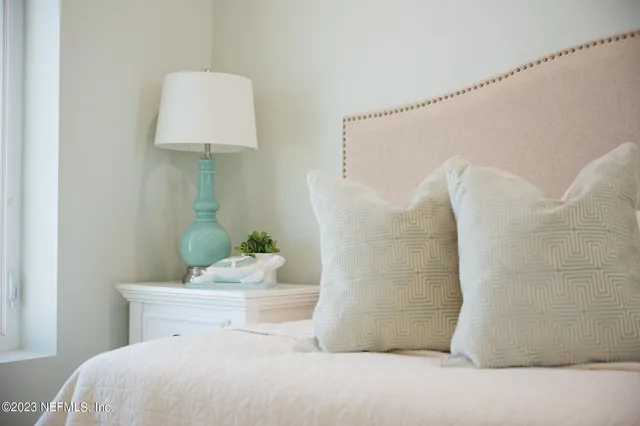 a bedroom with a bed and a table