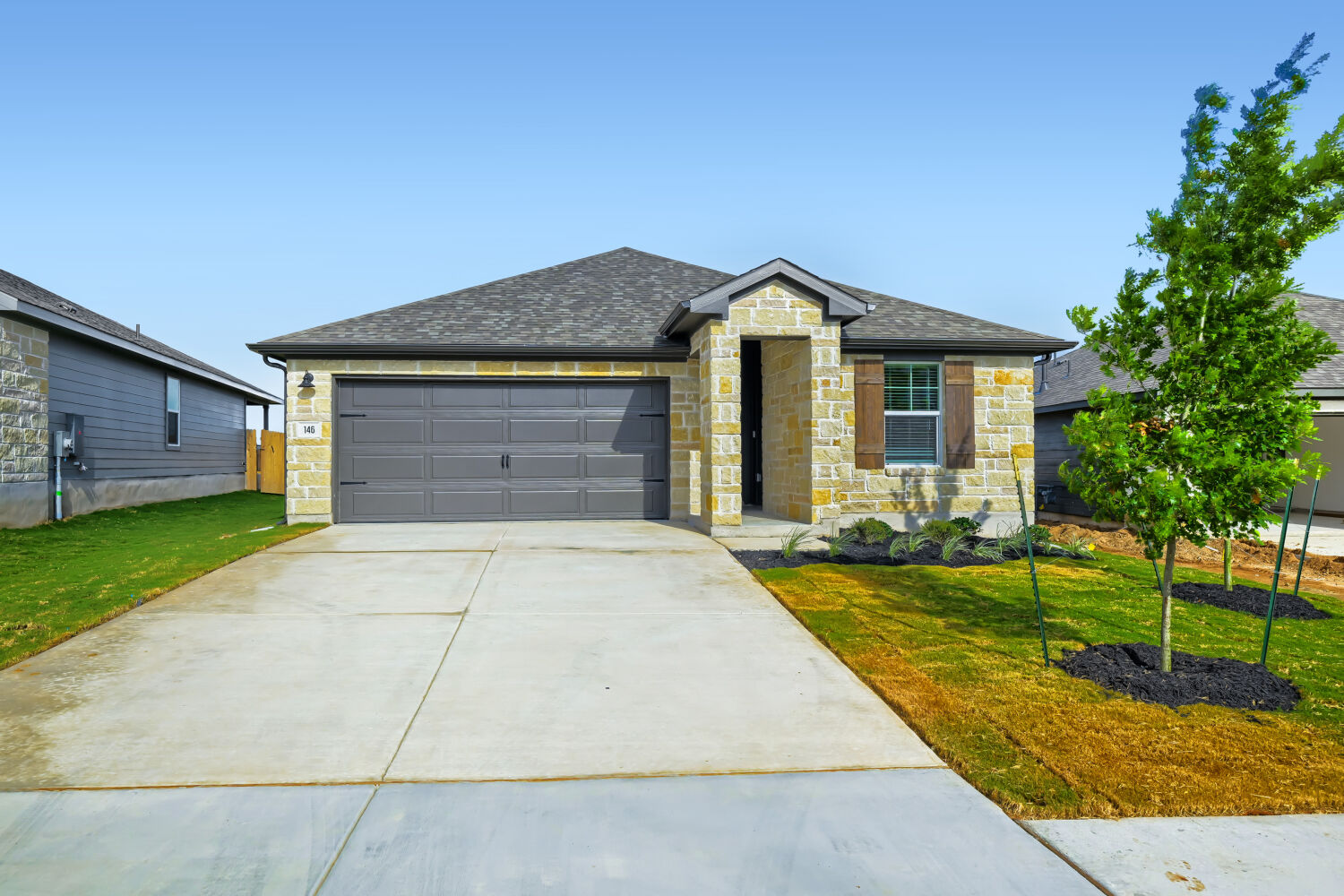 146 Diablo Rim Terrace Dripping Springs, TX 78620 - Photo 6 of 32 A charming single-story residence awaits, featuring a stone facade and a neatly landscaped front yard.