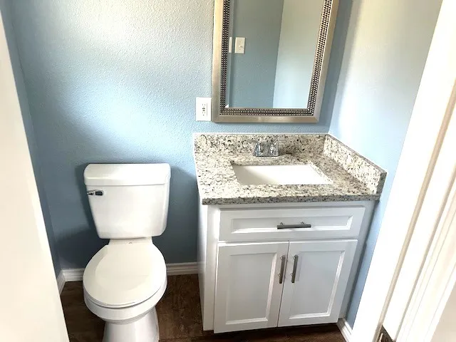 a bathroom with a toilet sink and mirror