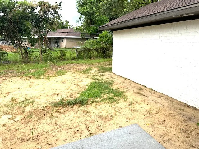 a view of a backyard of the house